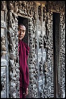 Monk pearing from window, Shwe In Bin Kyaung pagoda. Mandalay, Myanmar ( color)