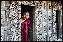Exquisitely carved teak walls and monk pearing, Shwe In Bin Kyaung pagoda. Mandalay, Myanmar ( color)