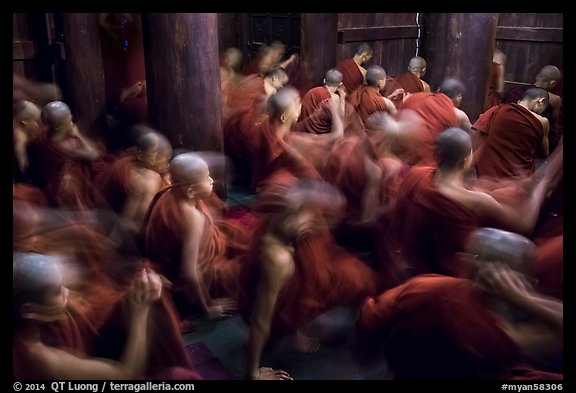Monks in motion during prayer. Mandalay, Myanmar (color)