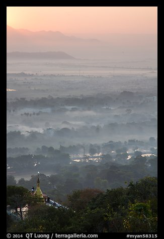 Fog shrouded plain below Mandalay Hill at sunrise. Mandalay, Myanmar (color)