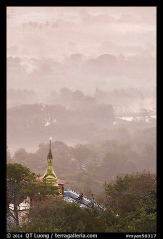 Stupa on Mandalay Hill overlooking misty plain. Mandalay, Myanmar (color)