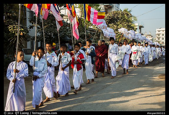 Children carry Buddhist flags ahead of alms procession. Mandalay, Myanmar (color)