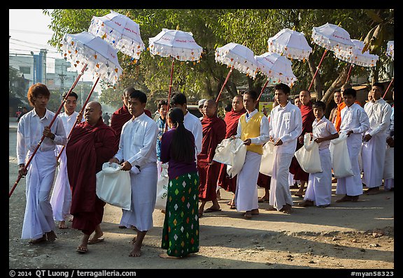 Umbrella bearer, Monks, and donation holders in alms procession. Mandalay, Myanmar (color)