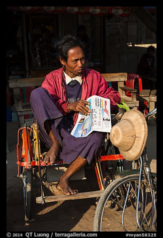 Sai kaa driver sitting on his rickshaw. Mandalay, Myanmar (color)