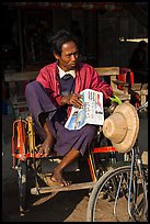 Sai kaa driver sitting on his rickshaw. Mandalay, Myanmar ( color)