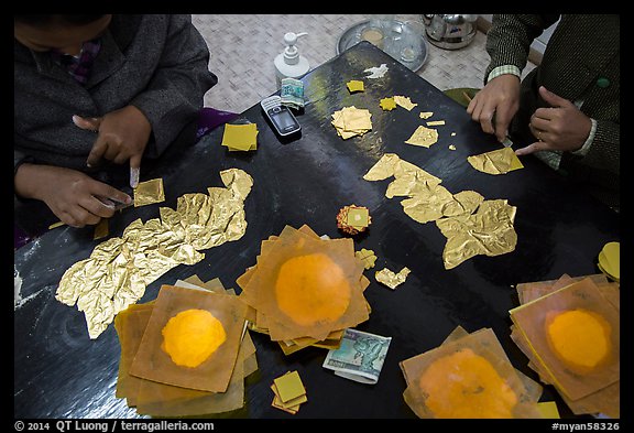 Gossamer-thin pieces of gold cut in squares, gold leaf workshop. Mandalay, Myanmar (color)
