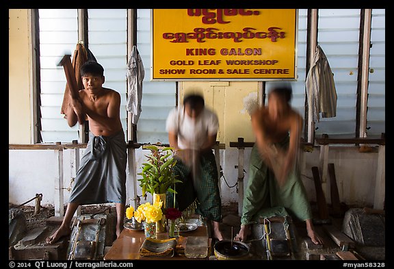 Men beat sheets of gold, gold leaf workshop. Mandalay, Myanmar (color)