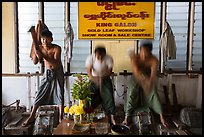 Men beat sheets of gold, gold leaf workshop. Mandalay, Myanmar ( color)