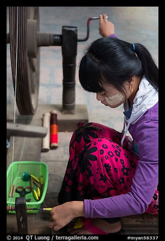 Woman assembling a yarn package. Amarapura, Myanmar (color)