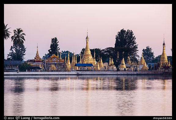 Pagoda reflected in Pone Tanoke Lake at dawn. Pindaya, Myanmar