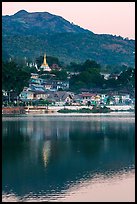 Hill and town reflected in Pone Tanoke Lake at dawn. Pindaya, Myanmar ( color)