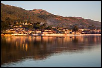 Hill and town reflected in Pone Tanoke Lake at sunrise. Pindaya, Myanmar ( color)