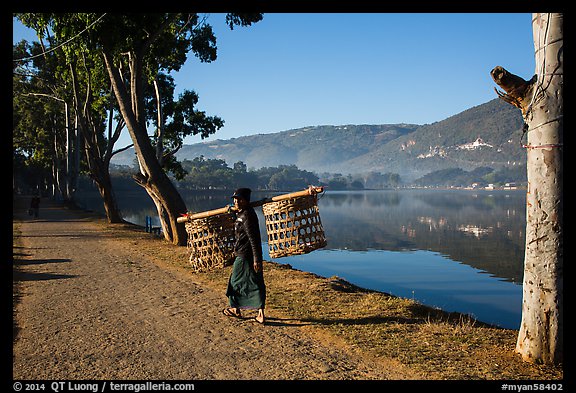 Man carrying baskets on road near Pone Tanoke Lake. Pindaya, Myanmar