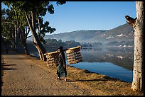 Man carrying baskets on road near Pone Tanoke Lake. Pindaya, Myanmar ( color)