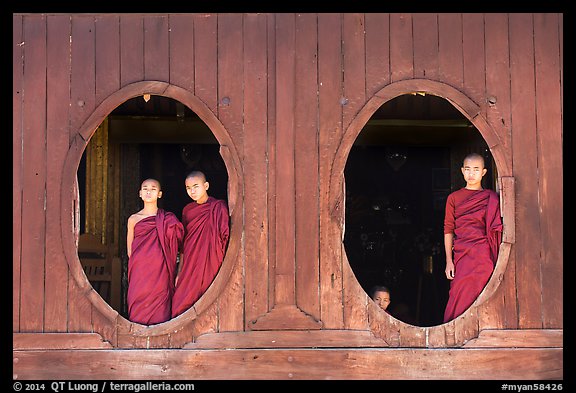 Monks standing in oval windows, Shweyanpyay Monastery, Nyaung Shwe. Inle Lake, Myanmar