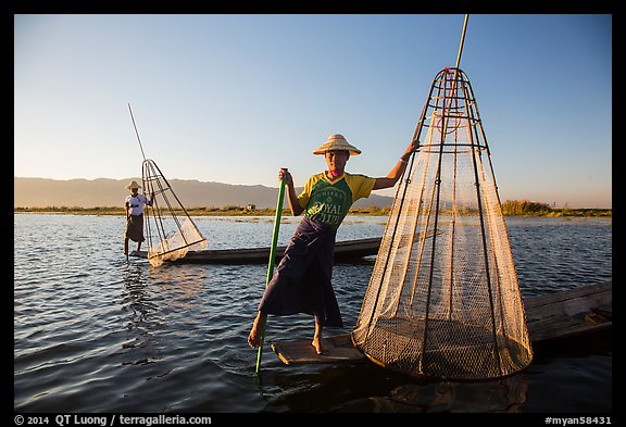 Intha fishermen with conical baskets in warm afternoon light. Inle Lake, Myanmar