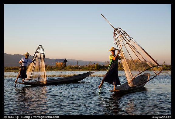 Intha fishermen row with leg and hold conical baskets. Inle Lake, Myanmar