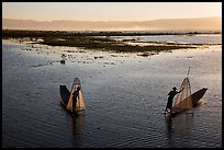 Intha fishermen row with backlit conical nets. Inle Lake, Myanmar ( color)
