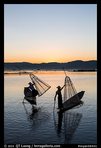 Intha fishermen lifting conical basket net at sunset. Inle Lake, Myanmar (color)