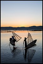 Intha fishermen lifting conical basket net at sunset. Inle Lake, Myanmar ( color)