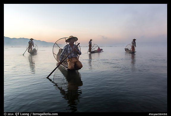 Group of Intha fishermen at dawn with surface mist. Inle Lake, Myanmar