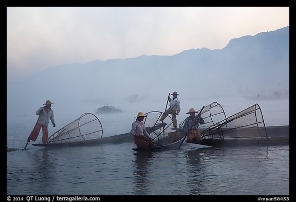 Intha fishermen gathering in dawn mist. Inle Lake, Myanmar