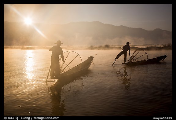 Sun piercing mist behind Intha fishermen. Inle Lake, Myanmar