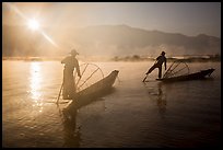 Sun piercing mist behind Intha fishermen. Inle Lake, Myanmar ( color)