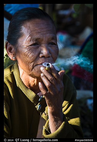 Woman smoking cheerot cigar. Inle Lake, Myanmar (color)