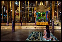 Woman praying at Nga Phe Kyaung monastery. Inle Lake, Myanmar ( color)