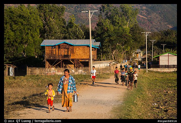 Villagers walking on path to jetty, Maing Thauk Village. Inle Lake, Myanmar