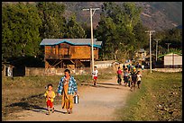 Villagers walking on path to jetty, Maing Thauk Village. Inle Lake, Myanmar ( color)