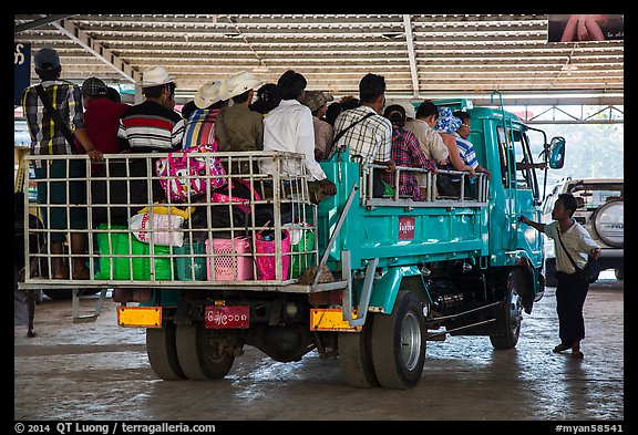Bus leaving base station with 35 passengers in the back. Kyaiktiyo, Myanmar (color)