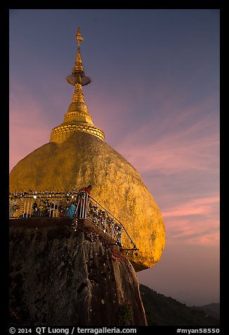 Monk standing on Golden Rock looks into the valley. Kyaiktiyo, Myanmar (color)