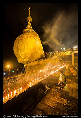 Offerings to the Buddha continues throughout the night at the Golden Rock. Kyaiktiyo, Myanmar (color)