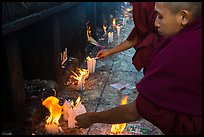 Monks lighting candles. Kyaiktiyo, Myanmar ( color)