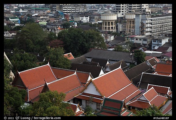 Temple roofs and modern buildings from above. Bangkok, Thailand (color)