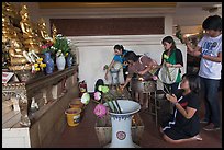 Worshippers with lotus inside Wat Saket. Bangkok, Thailand ( color)