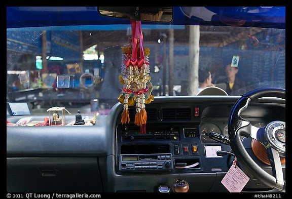 Bus dashboard with religious items. Thailand (color)