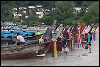 Women returning with shopping bags prepare to board boats, Ko Phi Phi. Krabi Province, Thailand ( color)