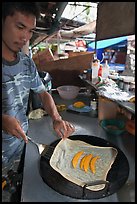Man preparing thai pancake, Tonsai village, Ko Phi Phi. Krabi Province, Thailand (color)