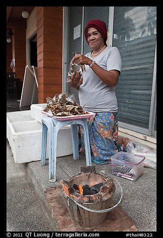 Woman selling grilled seafood, Tonsai village, Ko Phi-Phi island. Krabi Province, Thailand (color)