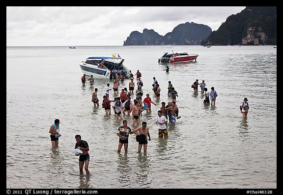 Asian tourists wading in water, Ko Phi Phi. Krabi Province, Thailand