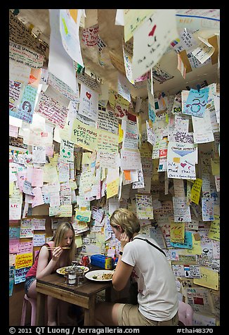 Women eating at Pad Thai restaurant decorated with customer notes, Ko Phi-Phi Don. Krabi Province, Thailand (color)