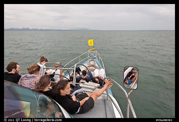 Passengers on prow of boat. Krabi Province, Thailand (color)