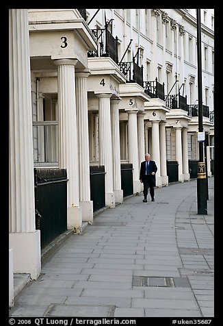 Businessman walking down near townhouses crescent. London, England, United Kingdom