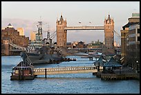 Historic boats, quays along the Thames, and Tower Bridge, late afternoon. London, England, United Kingdom