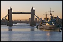 London Bridge, River Thames, and cruiser HMS Belfast at sunrise. London, England, United Kingdom
