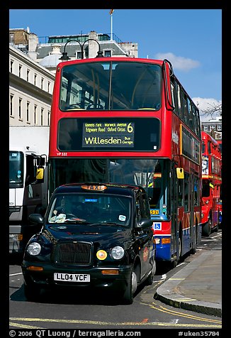 Taxi and double decker bus. London, England, United Kingdom (color)