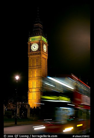 Double-decker bus in motion and Big Ben at night. London, England, United Kingdom (color)